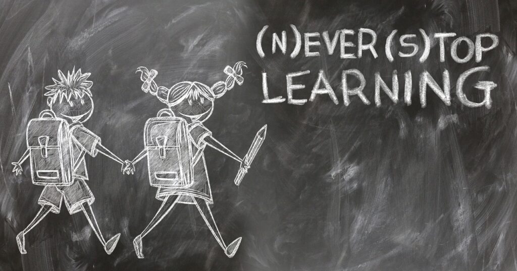never stop learning wrote on a blackboard