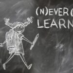 never stop learning wrote on a blackboard
