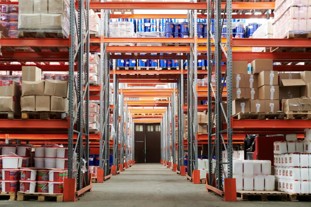 Wide angle view of a warehouse with stocked shelves and boxes.warehouse pest services