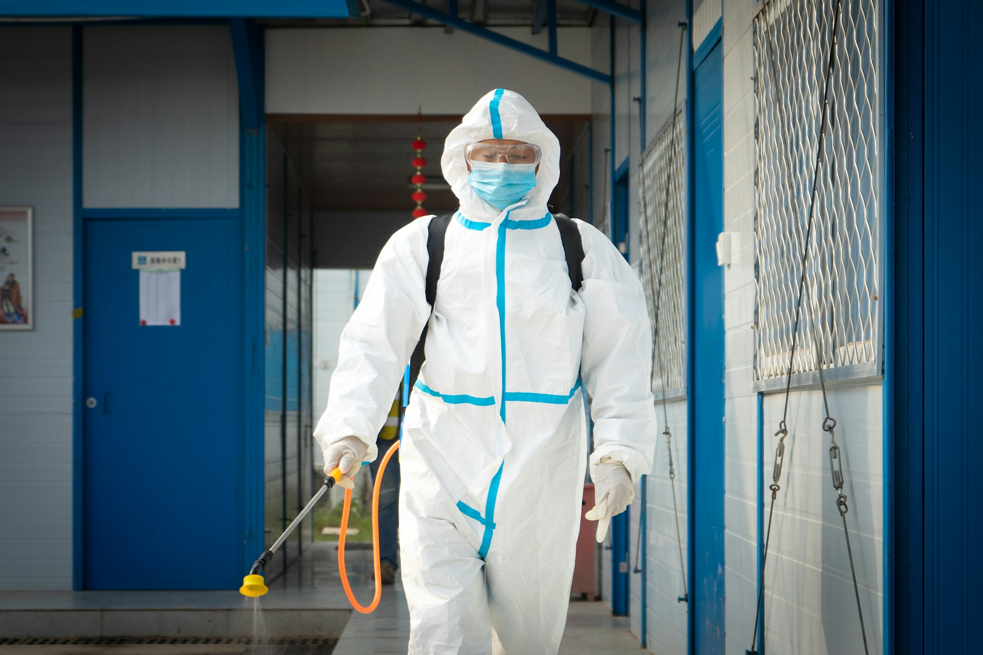 Commercial pest control technician in protective suit